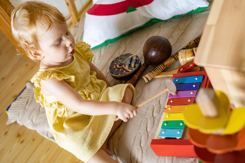 cute-baby-girl-playing-wooden-childish-xylophone-ecology-toys-maria-montessori-materials